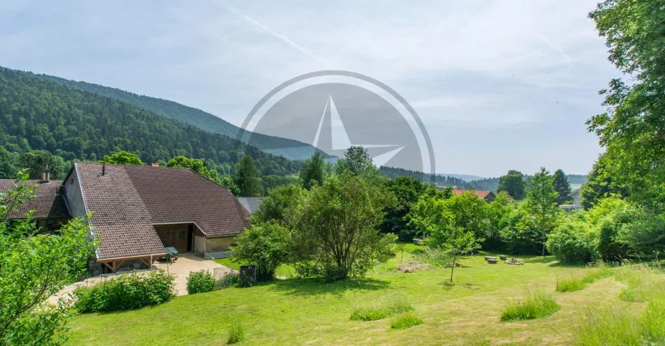 Ferme mitoyenne rénovée avec logements, grange et terrain à bâtir