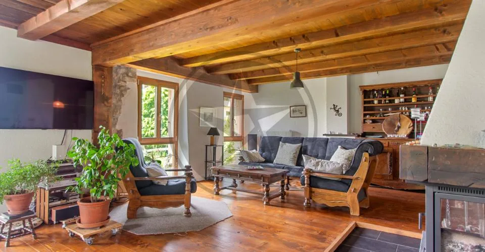 Ferme mitoyenne rénovée avec logements, grange et terrain à bâtir