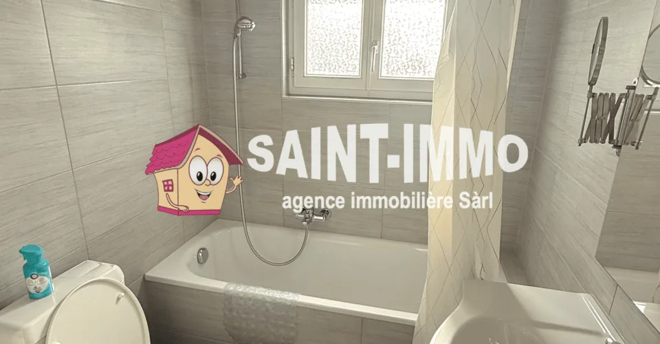 Maison familiale de deux appartements avec jardin, dépendance, terrasse, garage et places de stationnement à Sonceboz