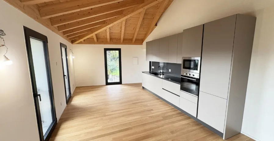 Exclusive Attic with Lake View in Pura - Modern Comfort in Idyllic Location