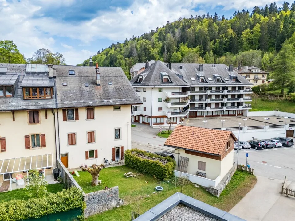 Mixed building in the heart of the village