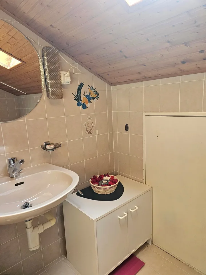 Zimmer mit möblierter Einrichtung und eigenem Badezimmer im Haushalt