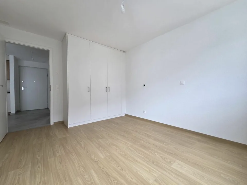 Neuf - Appartement de 2.5 pièces avec balcon et place de parc
