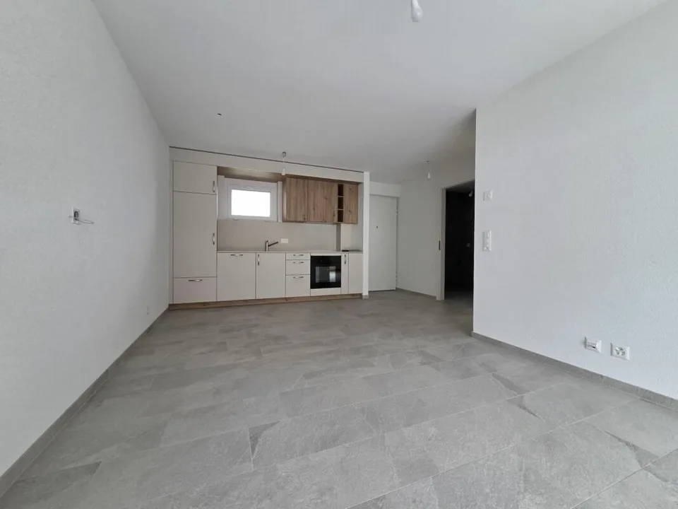Neuf - Appartement de 2.5 pièces avec balcon et place de parc
