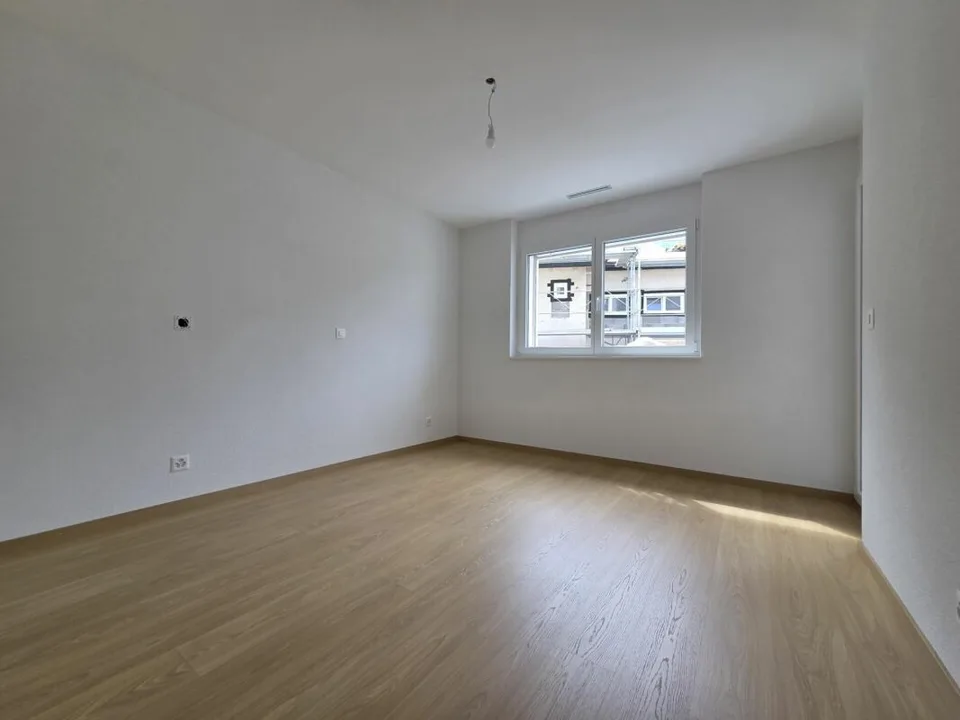 Neuf - Appartement de 2.5 pièces avec balcon et place de parc