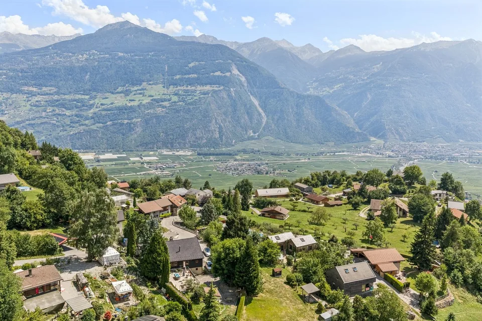 Semi-detached villa in a green setting.