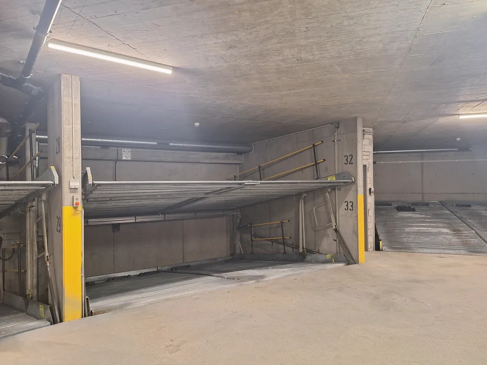 Very central parking space in a protected underground garage, on a car lift