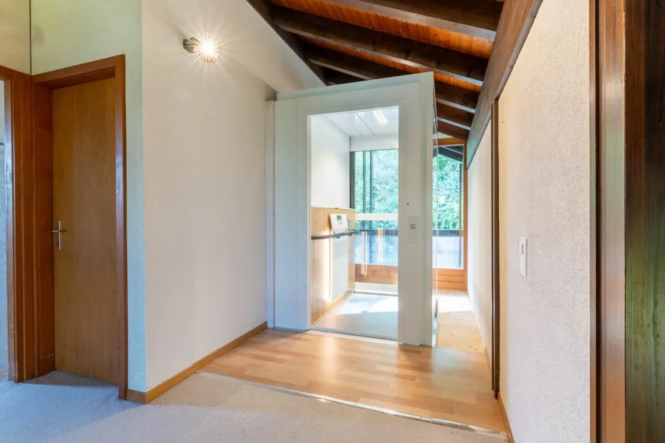 7.5-room living experience with gallery, lift, and pool on the edge of the forest