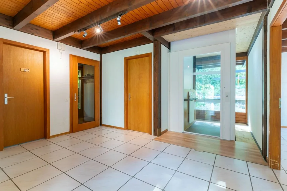 7.5-room living experience with gallery, lift, and pool on the edge of the forest