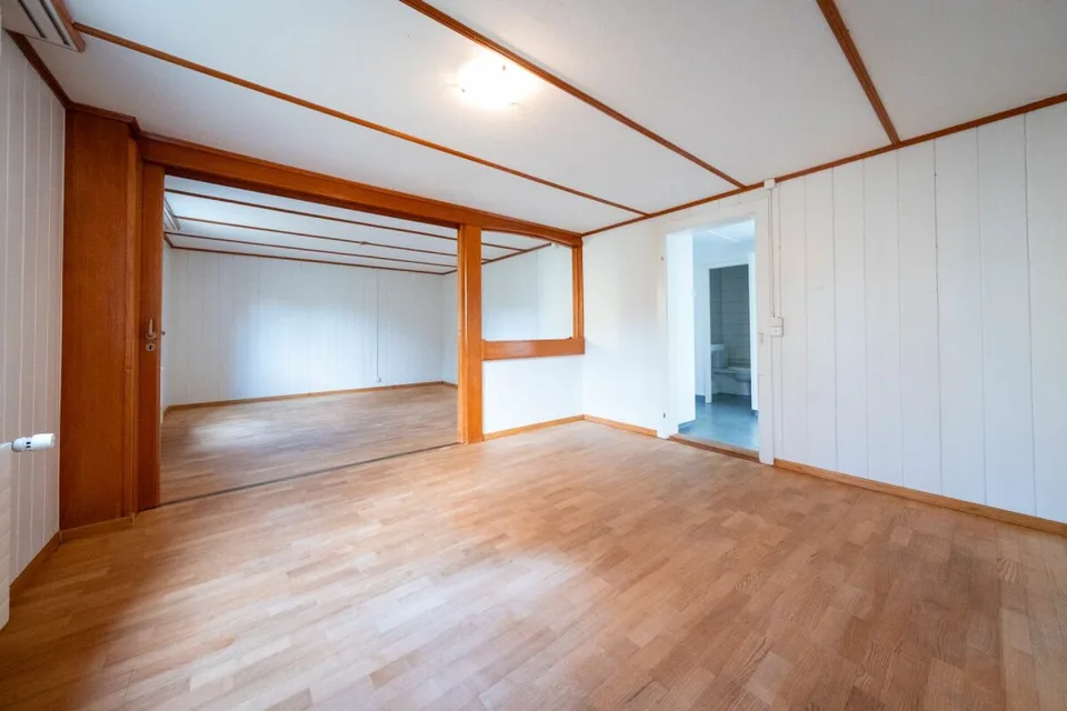 Two-family house with garages, workshop, and storage rooms for sale