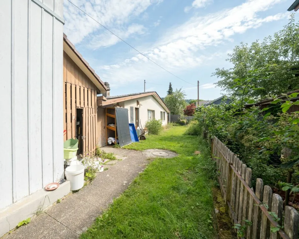 Two-family house with garages, workshop, and storage rooms for sale