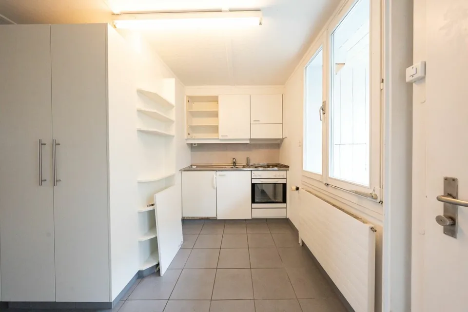 Two-family house with garages, workshop, and storage rooms for sale