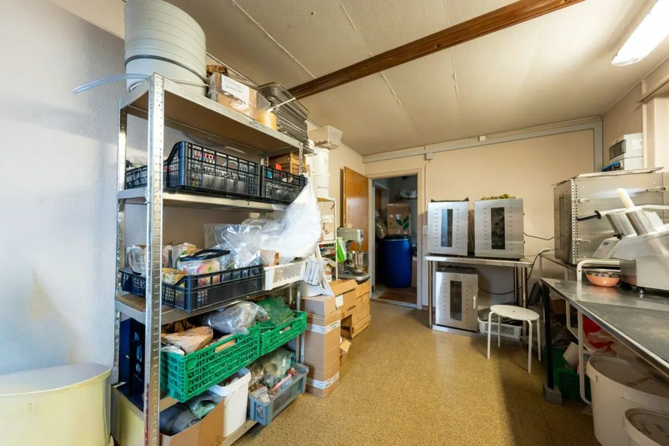 Two-family house with garages, workshop, and storage rooms for sale