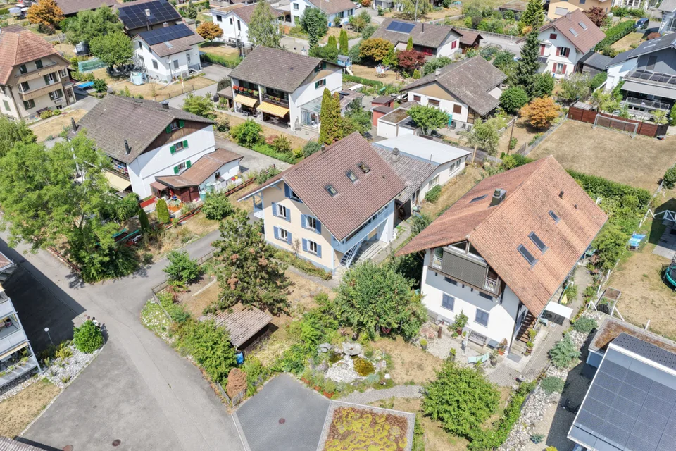 Two-family house with garages, workshop, and storage rooms for sale