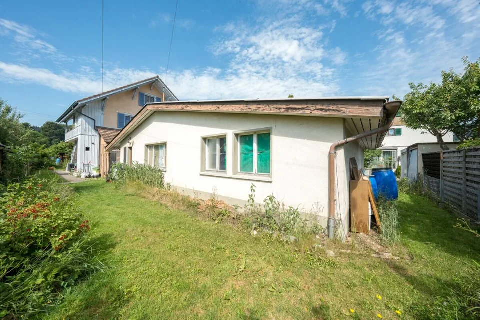 Two-family house with garages, workshop, and storage rooms for sale