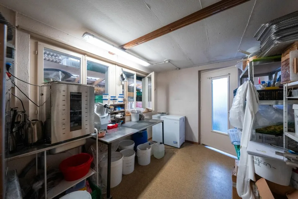 Two-family house with garages, workshop, and storage rooms for sale
