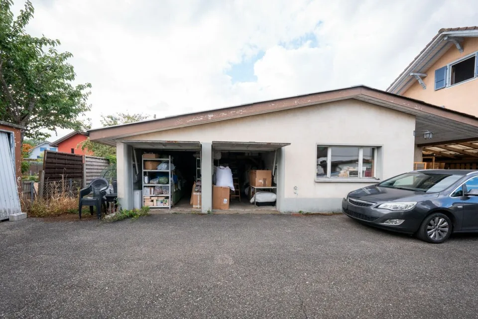 Two-family house with garages, workshop, and storage rooms for sale
