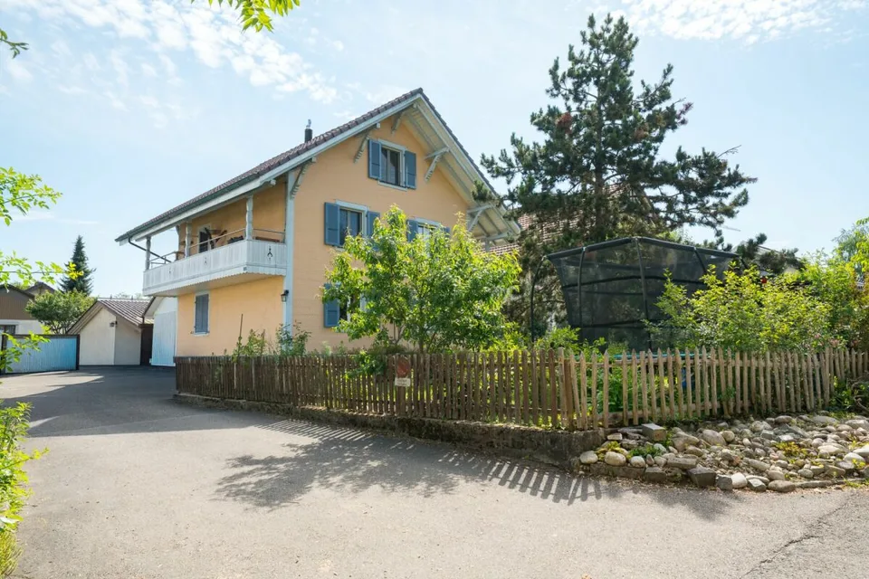Two-family house with garages, workshop, and storage rooms for sale