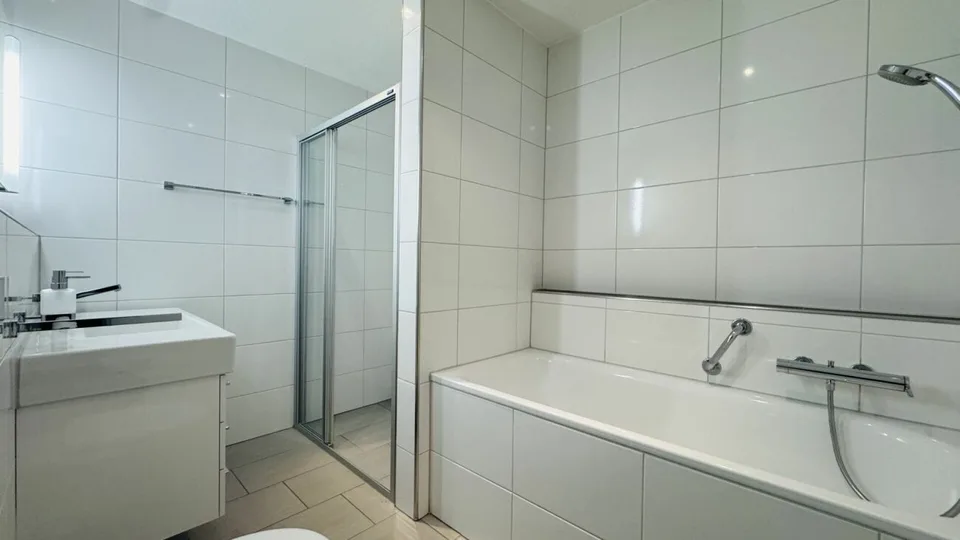 4.5-room maisonette with balcony, 2 wet cells, 2 underground parking spaces, laundry tower, and basement