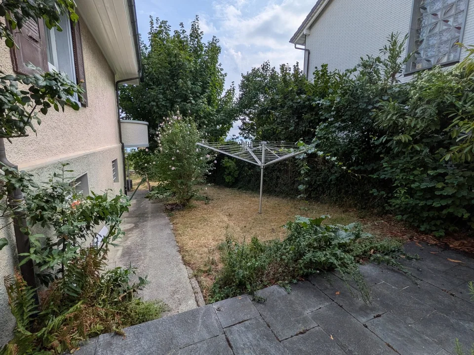 Grande duplex di 6.5 locali con vista panoramica sul lago e le Alpi, giardino privato