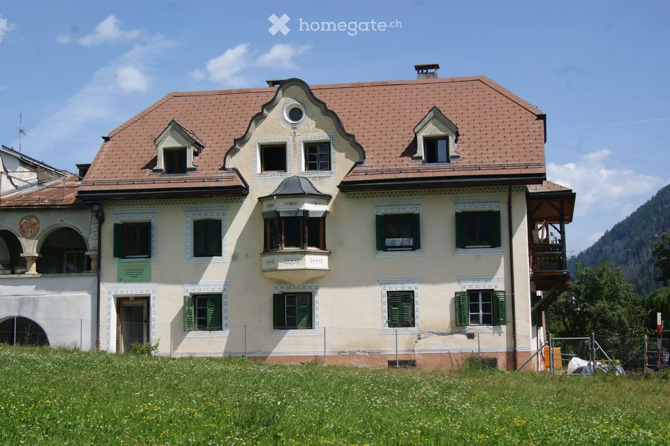 In Müstair in a historic residential building in a quiet, sunny location with a view of the mountains