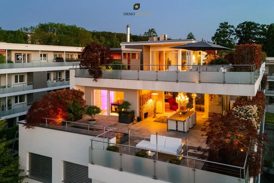Exclusive attic maisonette with pool, whirlpool, sauna, and lake view.