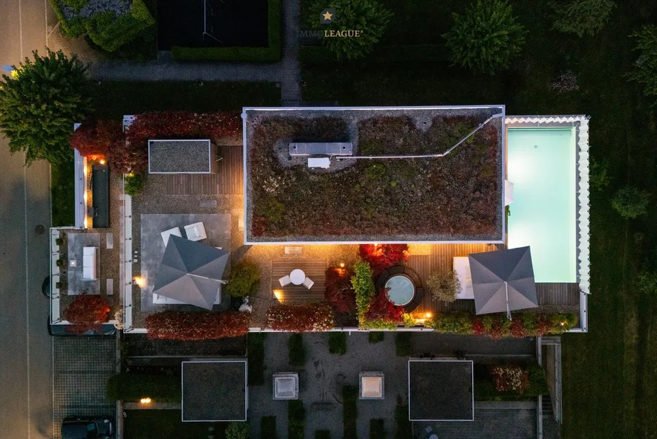 Exclusive attic maisonette with pool, whirlpool, sauna, and lake view.