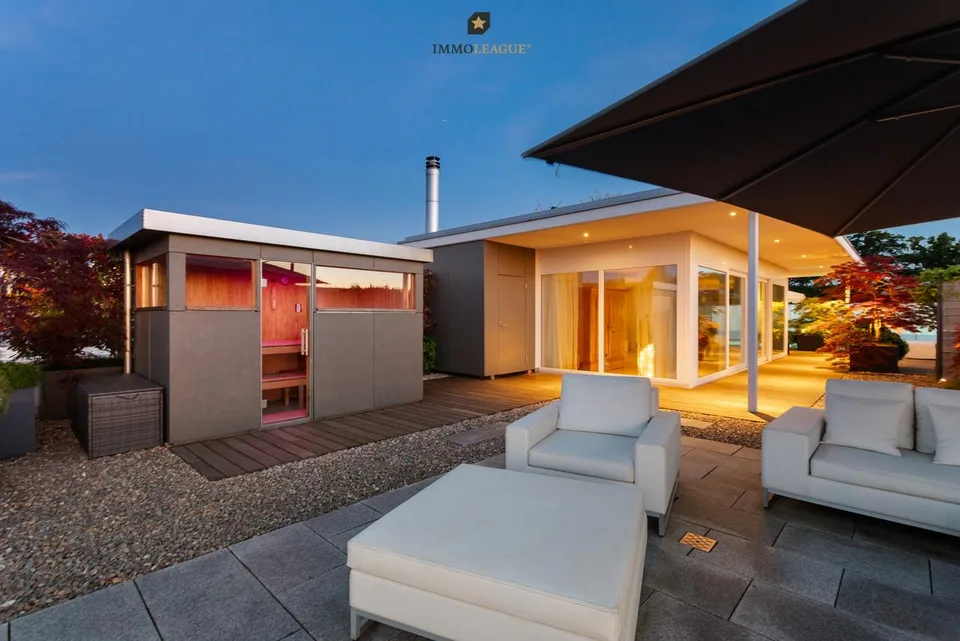 Exclusive attic maisonette with pool, whirlpool, sauna, and lake view.