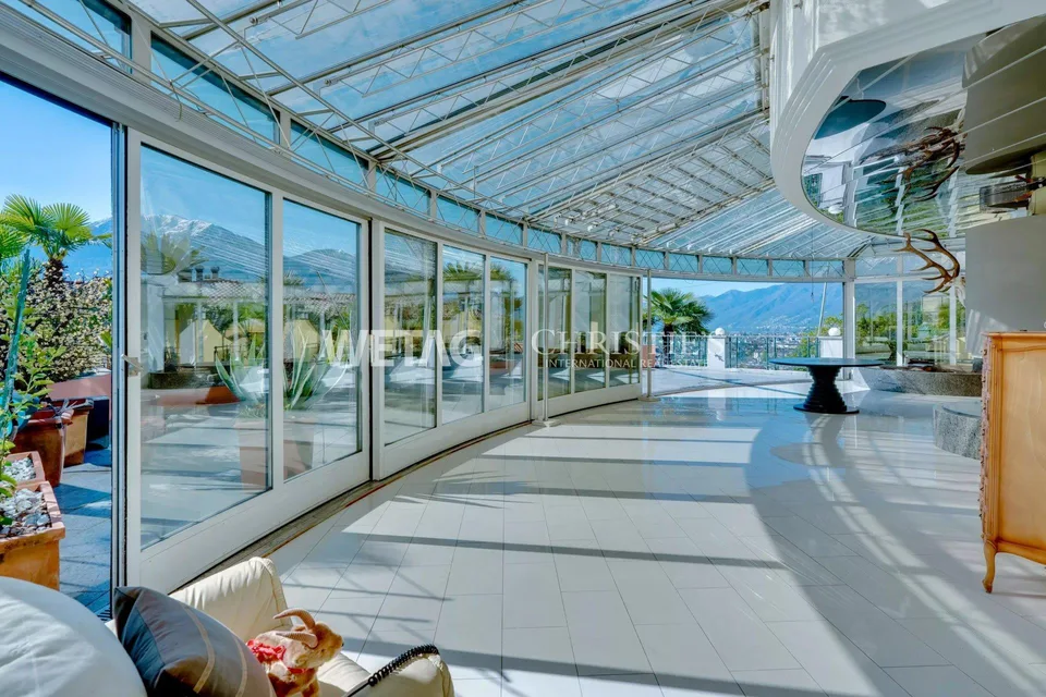 Muralto: Modern, bright apartment with large terrace & elegant glass architecture for sale