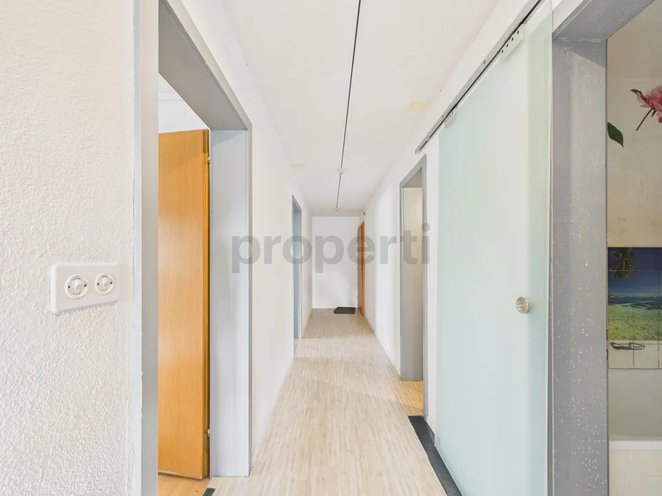 Light-filled living with balcony and far-reaching views