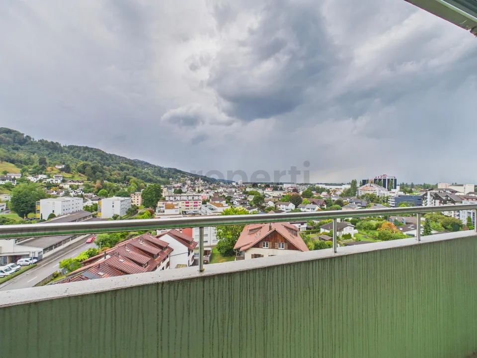 Light-filled living with balcony and far-reaching views