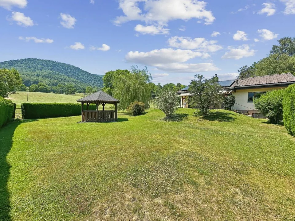 Single-family house on one level on the edge of an agricultural area with a stream
