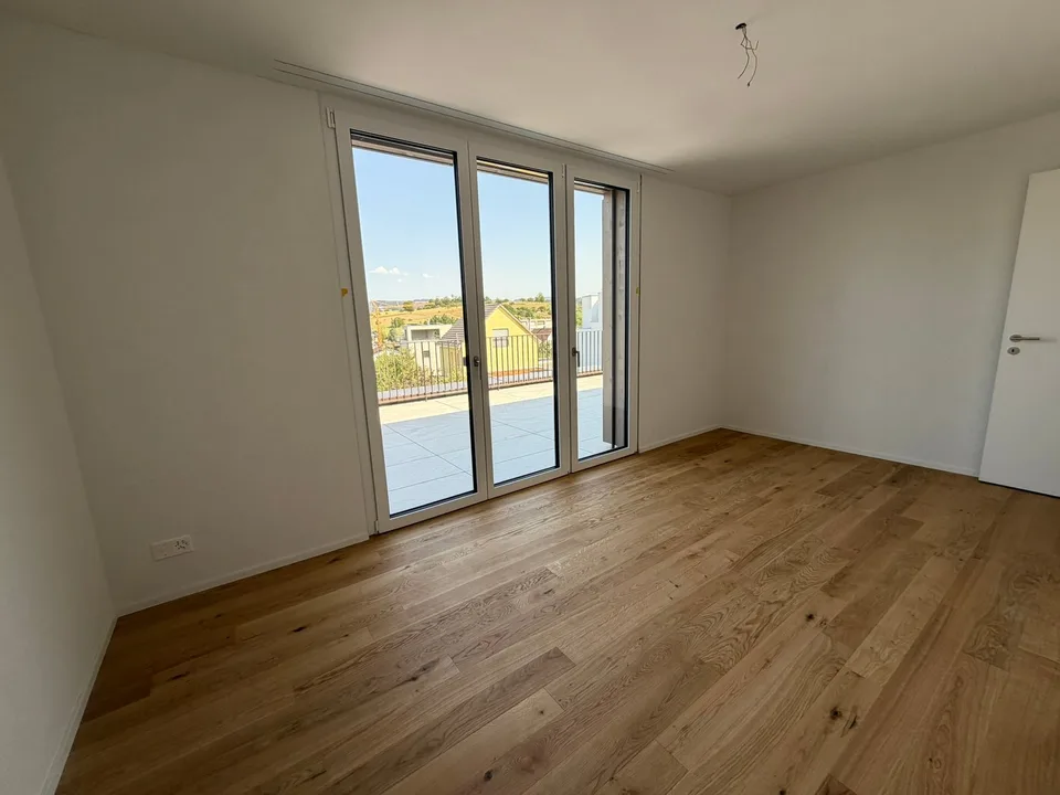 Appartamento mansardato moderno 2.5 locali in un edificio nuovo con una terrazza spaziosa