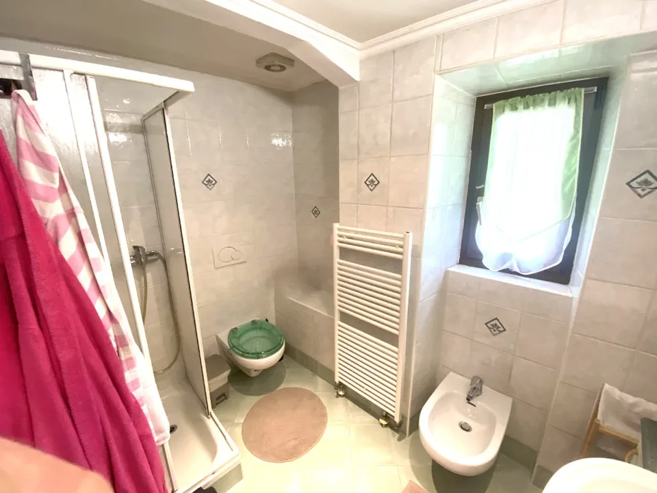 Renovated 7-room core house with garden, grotto, and attic.