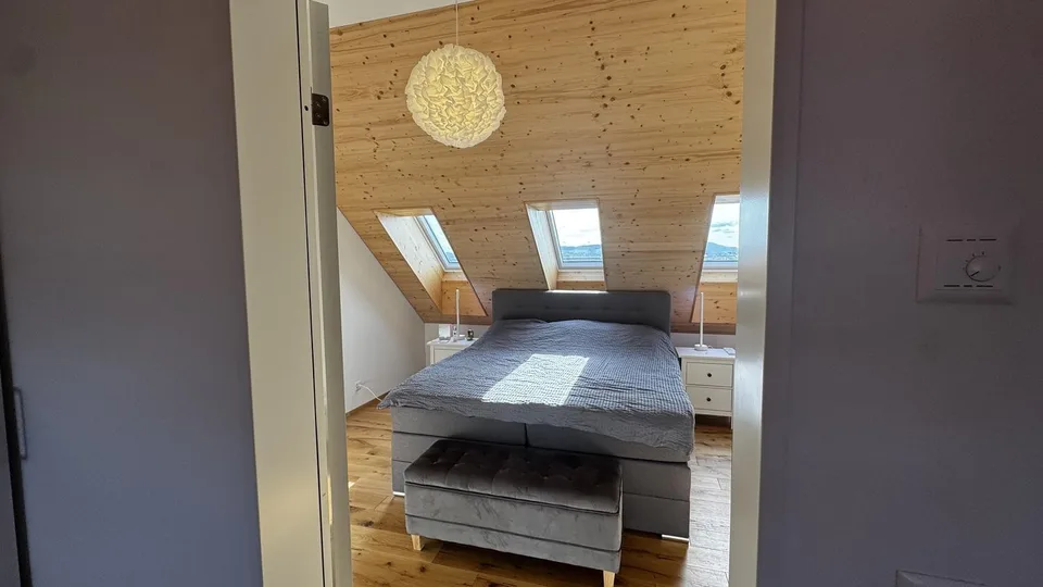 Bright attic apartment with modern renovation and charming wood details