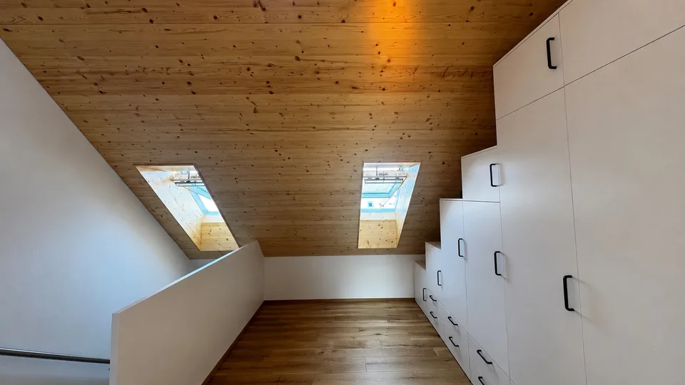 Bright attic apartment with modern renovation and charming wood details